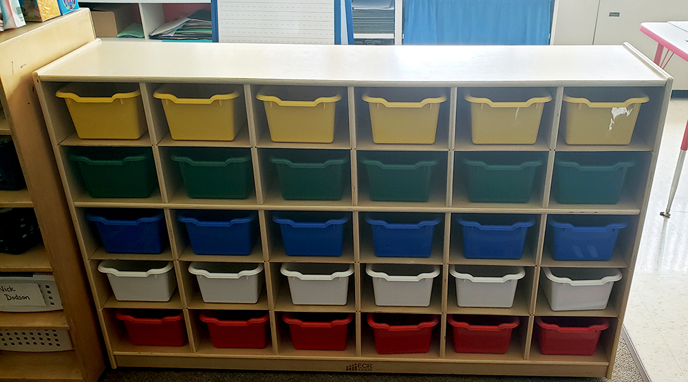 Photo of classroom storage bins in multiple colors.