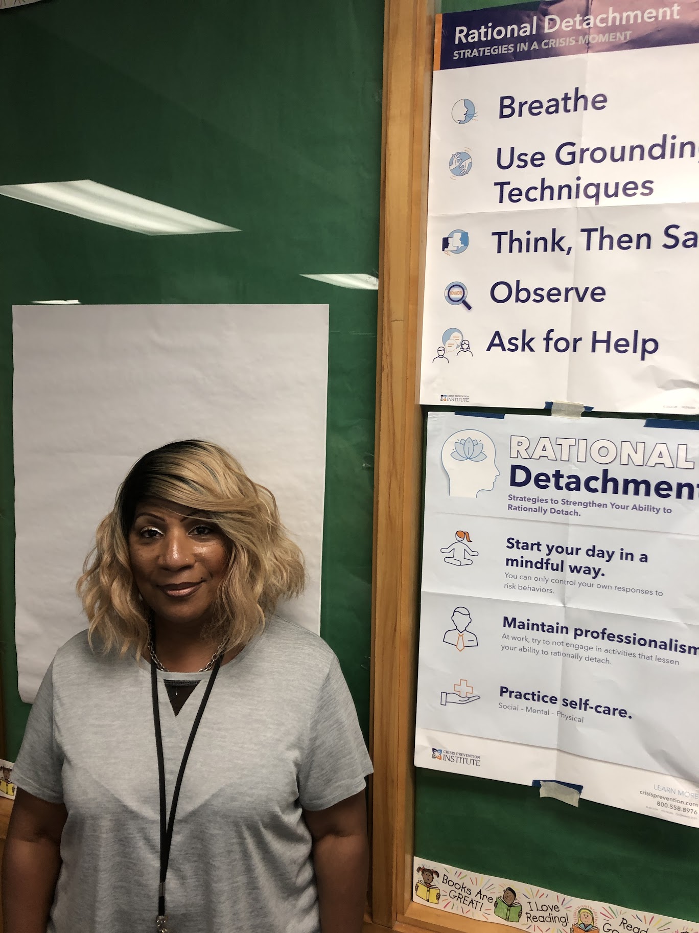 A photo of Toni Brown smiling in front of a data display