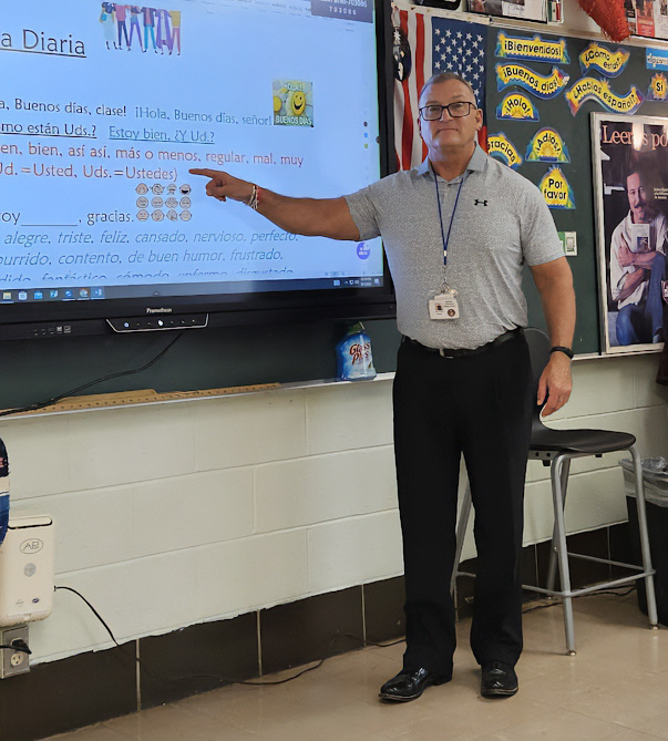 A photo of Robert Fenton smiling in his classroom