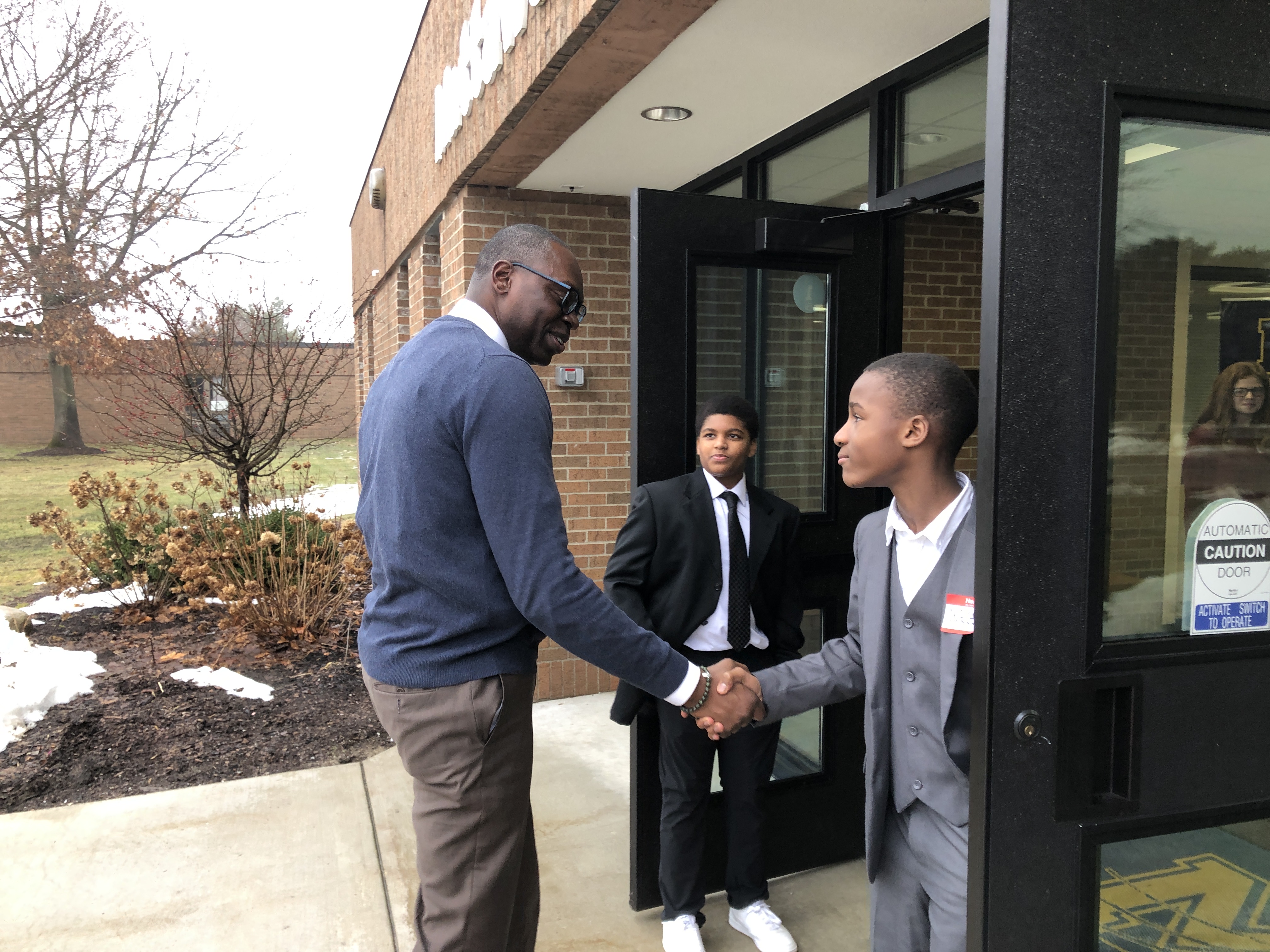 A picture of Lt. Governor Gilchrist shaking hands with a student.