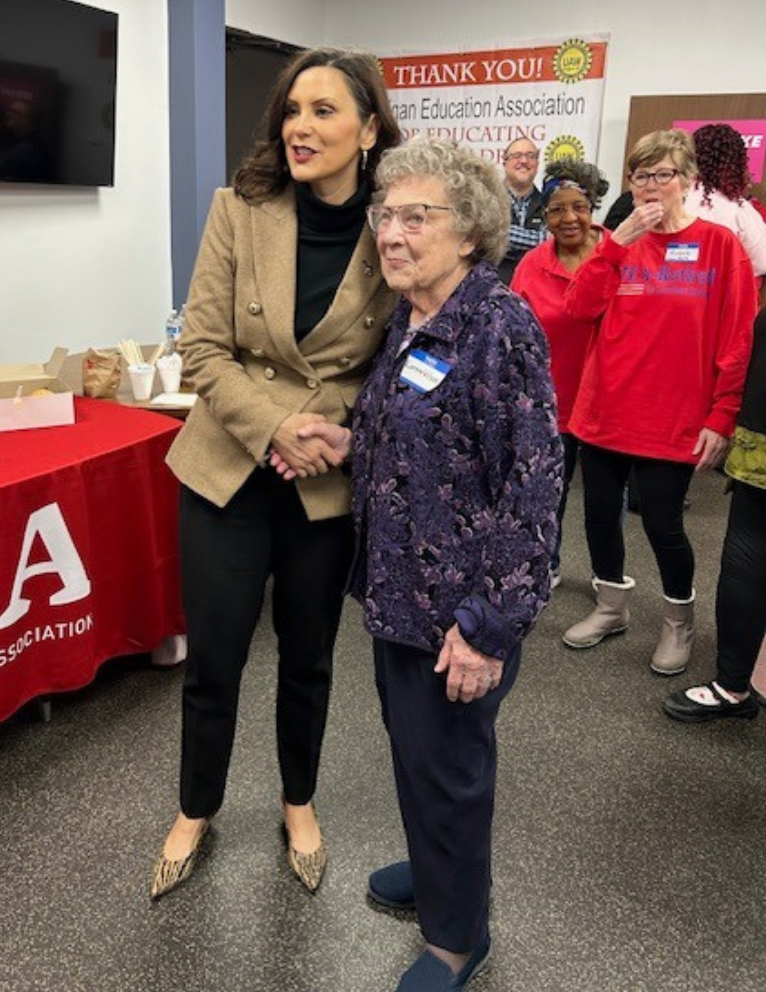 A photo of Governor Whitmer smiling with Lorene Wilson.