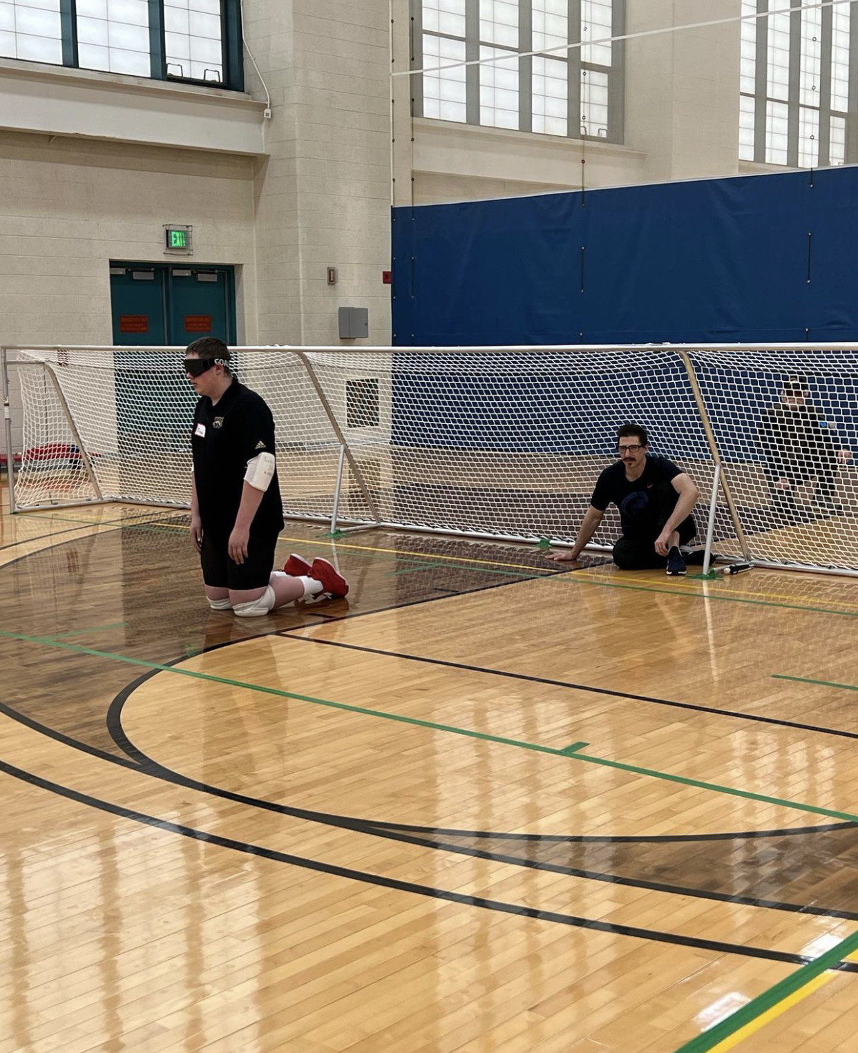 Kusku sits in the 30-foot-wide goal that players defend in the sport of goalball, invented for visually impaired athletes. 